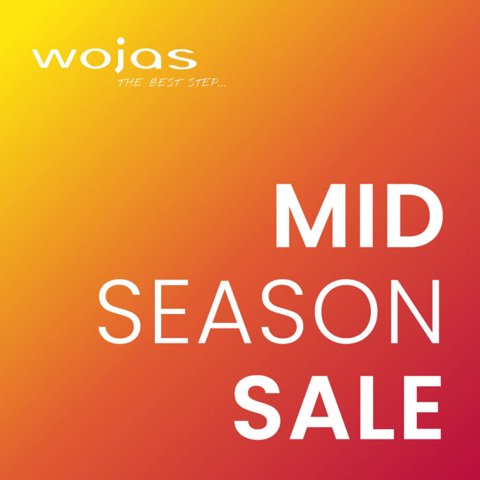 Baner promocyjny w pomarańczowo żółtym kolorze - Mid season sale w salonach Wojas